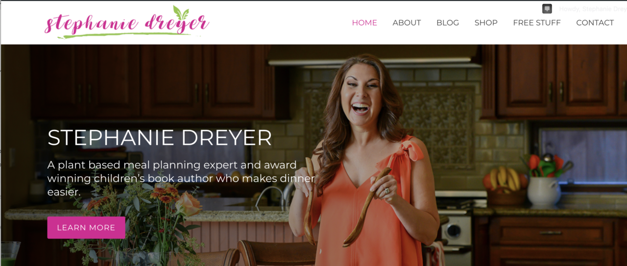 screenshot of website home page featuring a woman smiling and tossing a salad at the dining room table